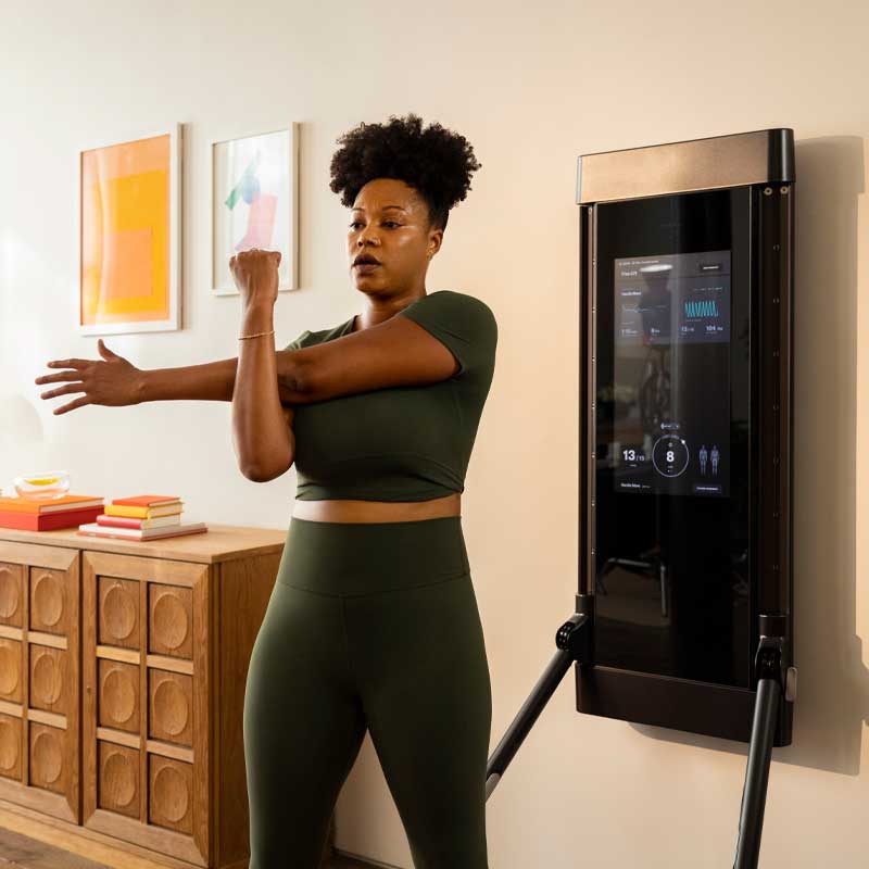 Woman working out with fitness programs on Tonal. 