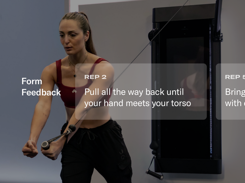 Woman exercising using a Tonal trainer with feedback text overlayed on image