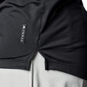 Close up of bottom hem of black Men's Tonal Performance Shop long sleeve shirt