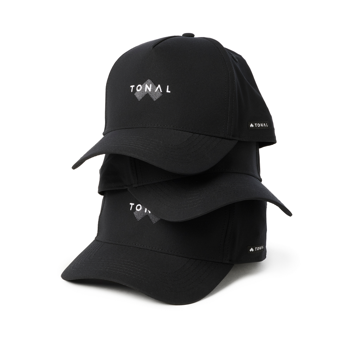 Multiple black Tonal baseball hats stacked on one another