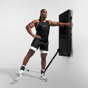 Man using Tonal Ankle straps in his workout