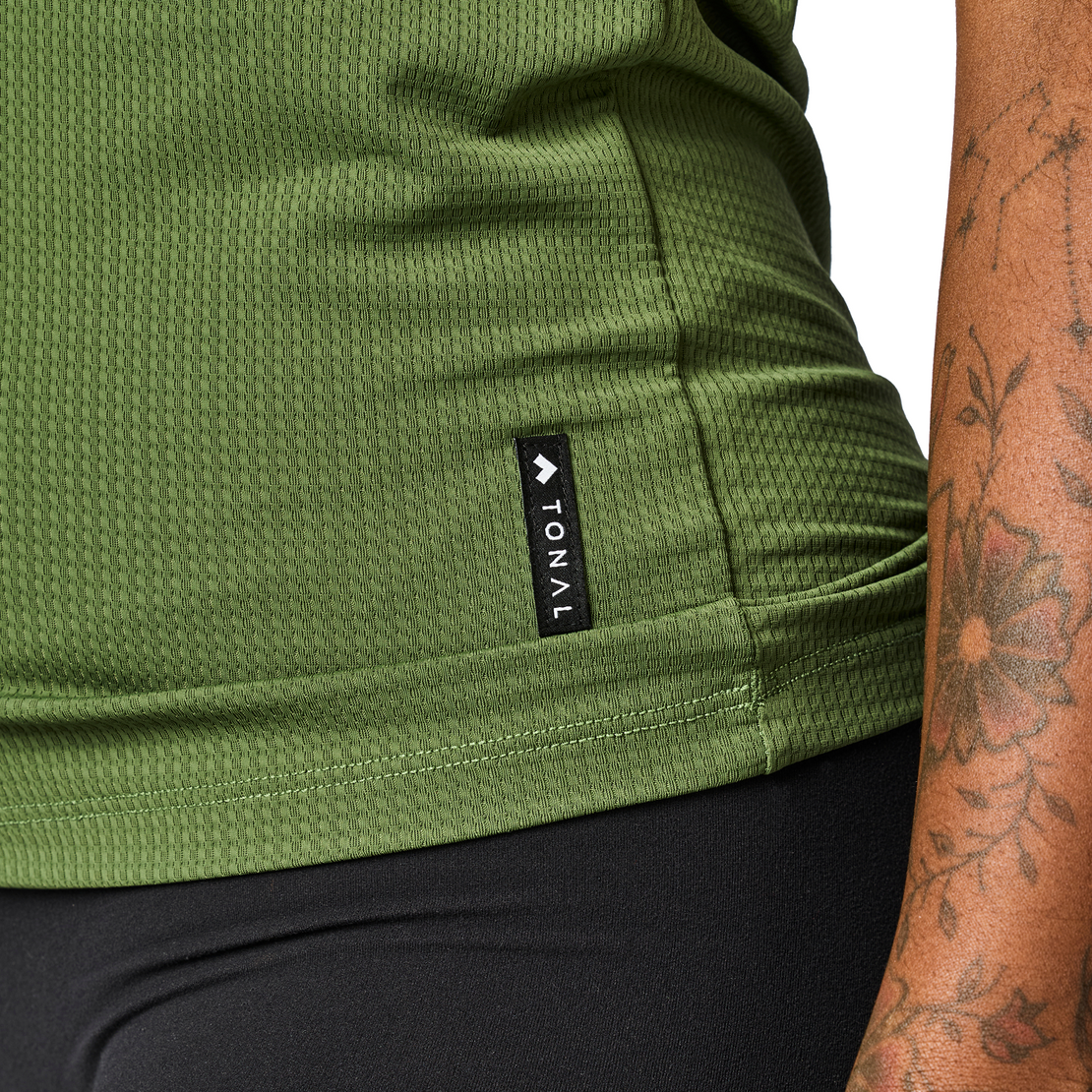 Close up of Tonal Performance Lifestyle Tee fabric and bottom hem