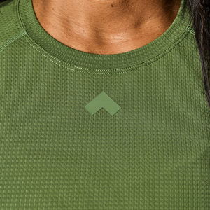 Close up of Dark Sage Tonal Performance Lifestyle Tee fabric and Tonal logo on chest