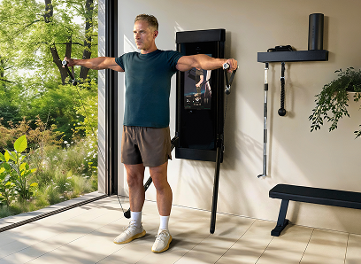 Man doing lateral raises using Tonal machine in a home setting